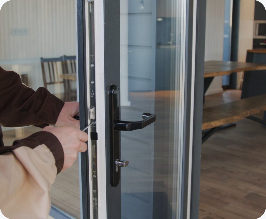 Locksmith fitting a door lock in East London